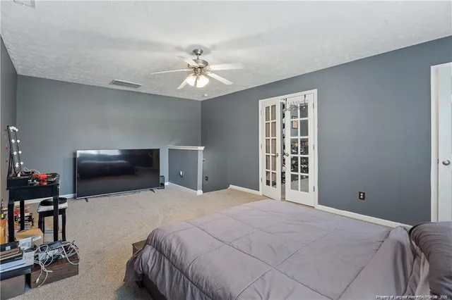a bedroom with a bed and a chandelier