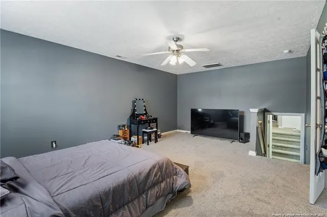 a bed room with a bed and a tv