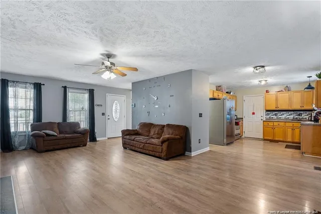 a living room with furniture and kitchen view