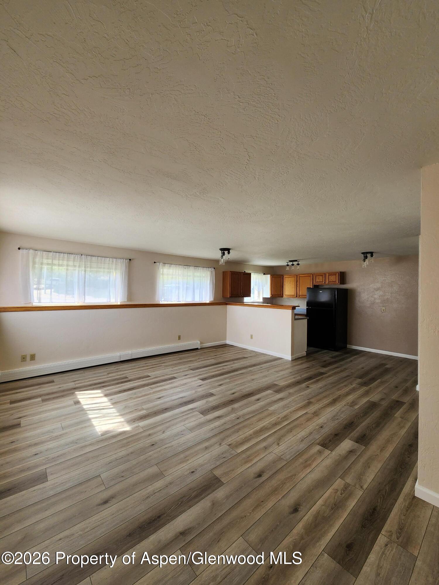 883 Taugenbaugh Boulevard Rifle, CO 81650 - Photo 8 of 18 a view of empty room with wooden floor