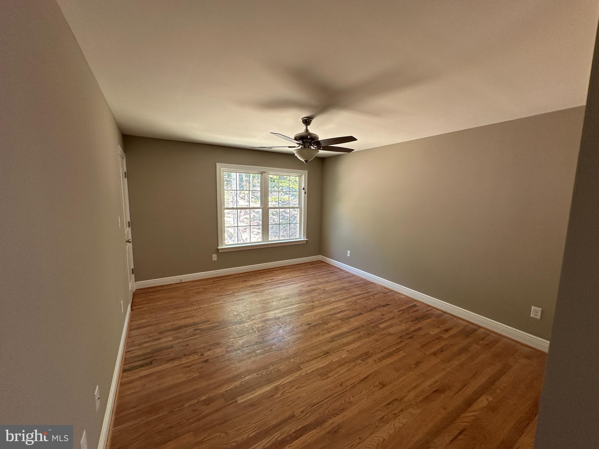 211 Inca Trail Winchester, VA 22602 - Photo 11 of 23 an empty room with wooden floor fan and windows