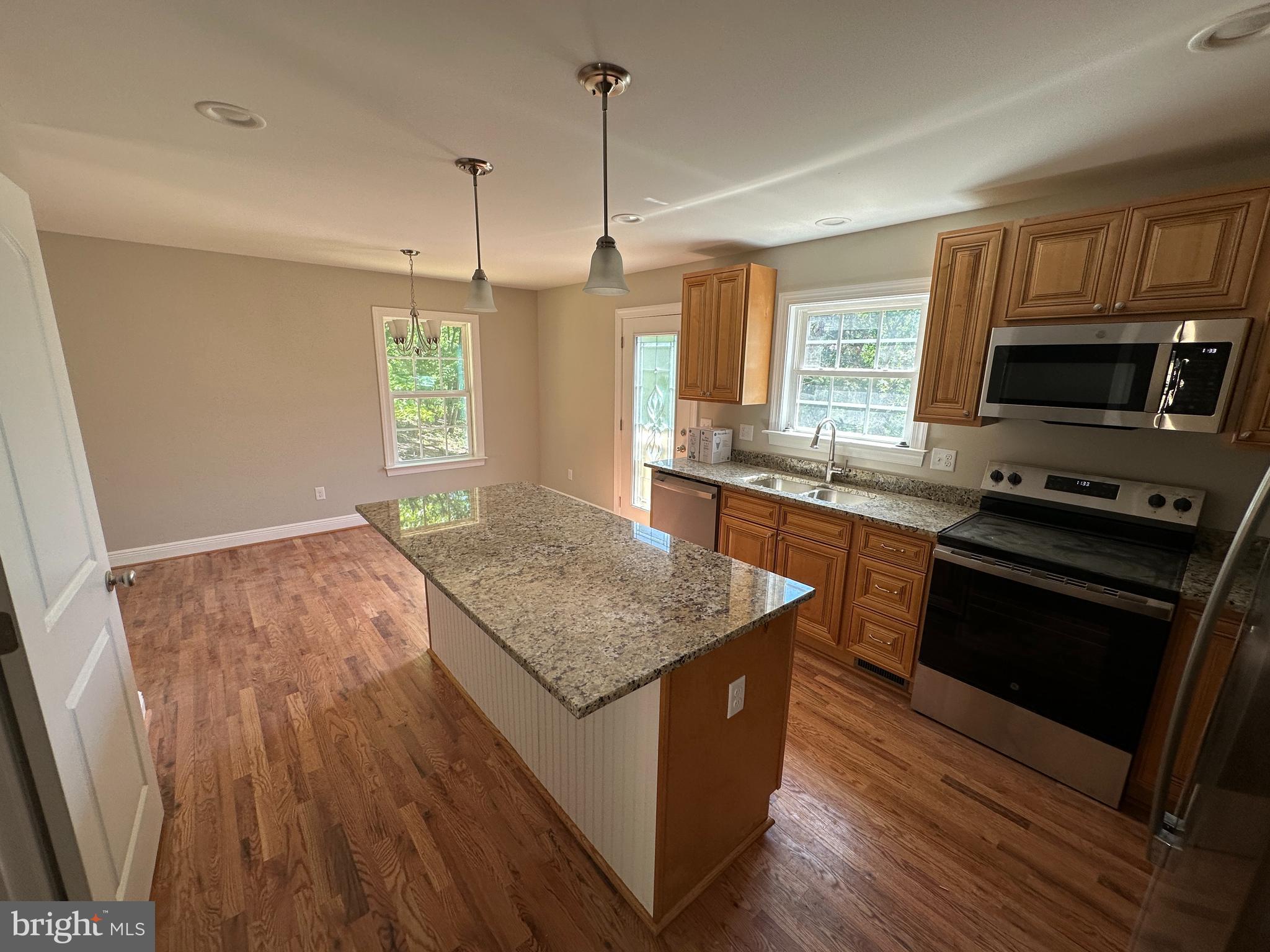 211 Inca Trail Winchester, VA 22602 - Photo 8 of 23 a kitchen with stainless steel appliances granite countertop a stove a sink and a microwave