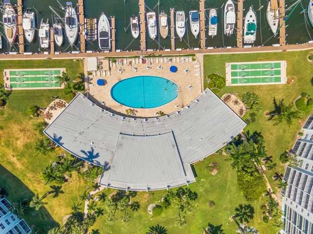 a view of a swimming pool with a yard and plants