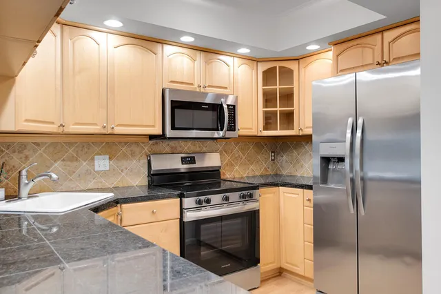 a kitchen with a stove a sink and a microwave