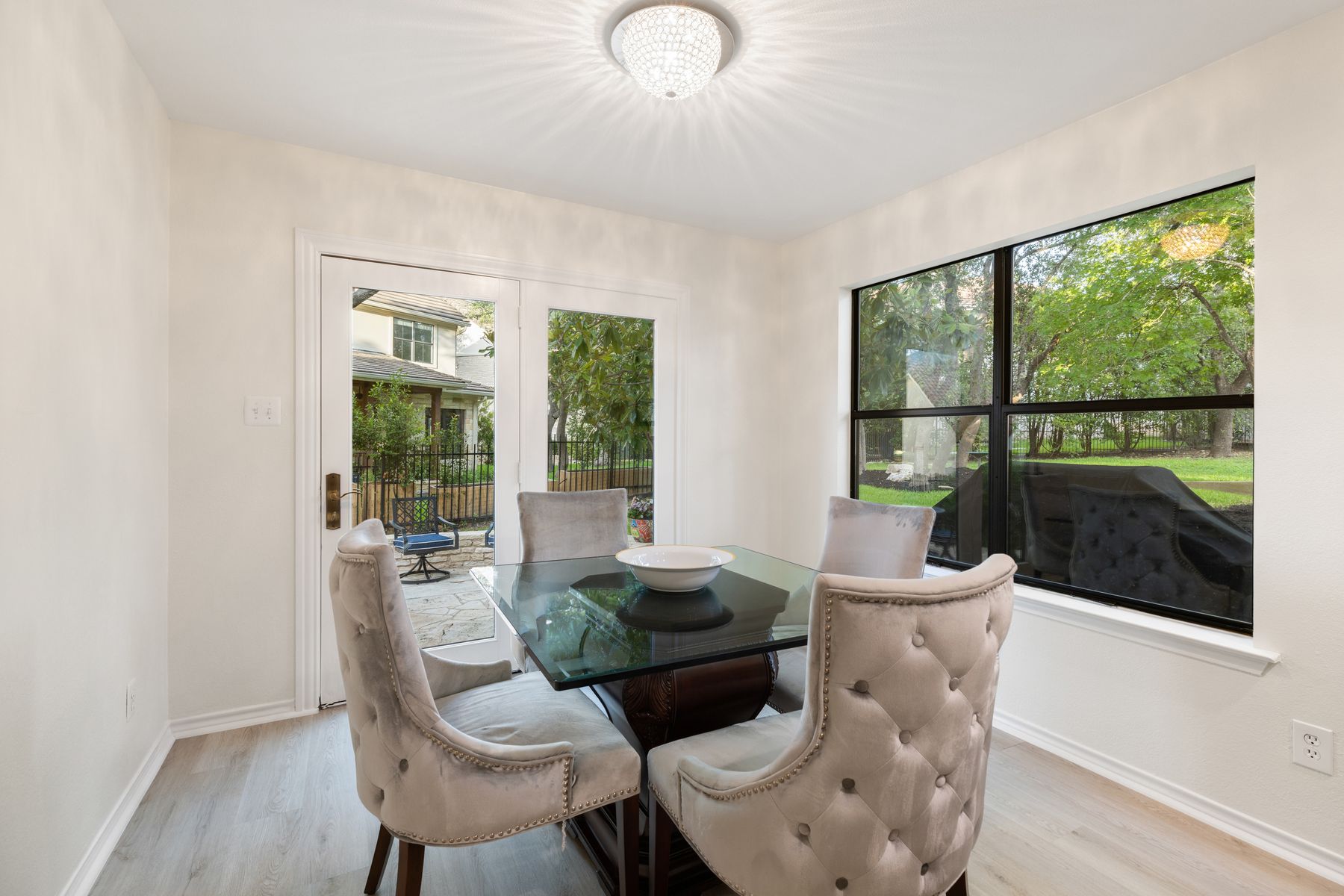 5 Valhalla Court The Hills, TX 78738 - Photo 12 of 34 Light-filled breakfast nook with patio access and peaceful backyard views.