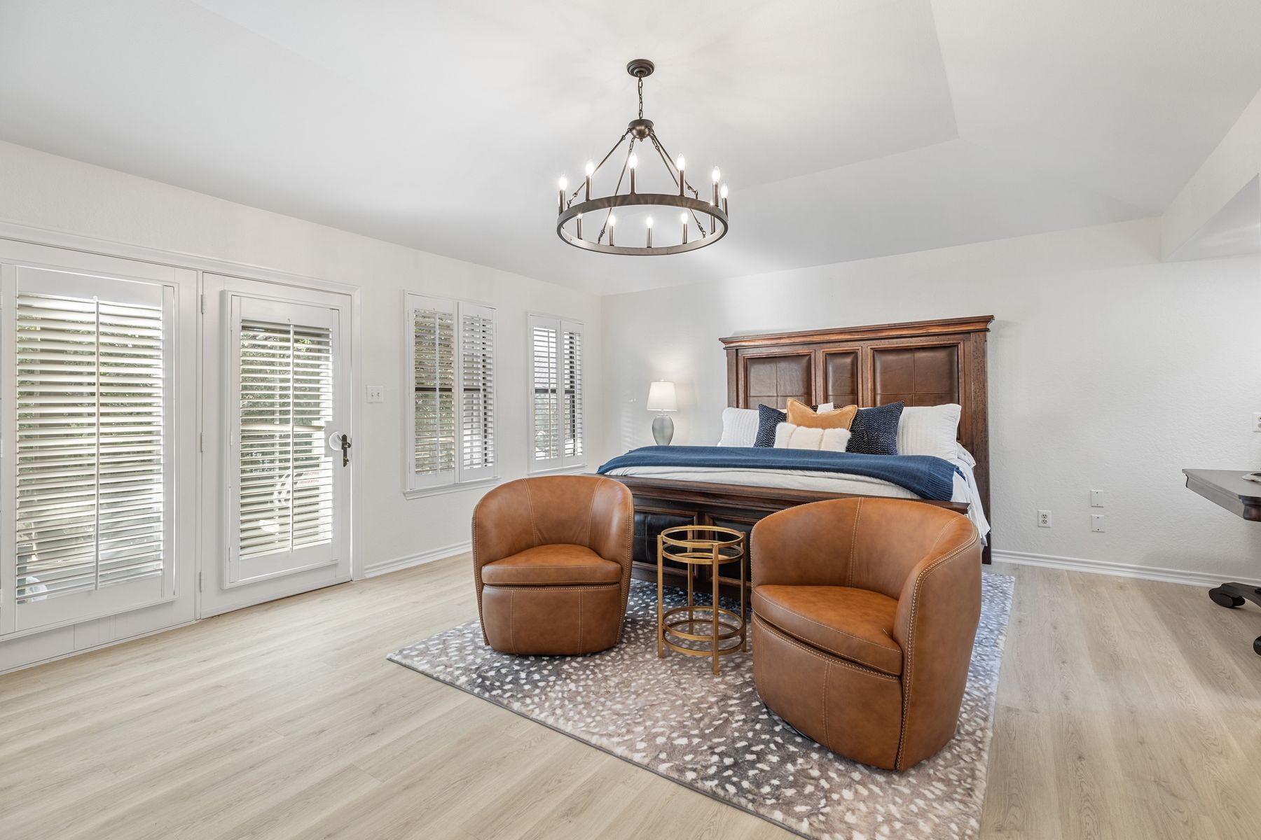 5 Valhalla Court The Hills, TX 78738 - Photo 13 of 34 Spacious primary suite with vaulted ceilings and statement chandelier.