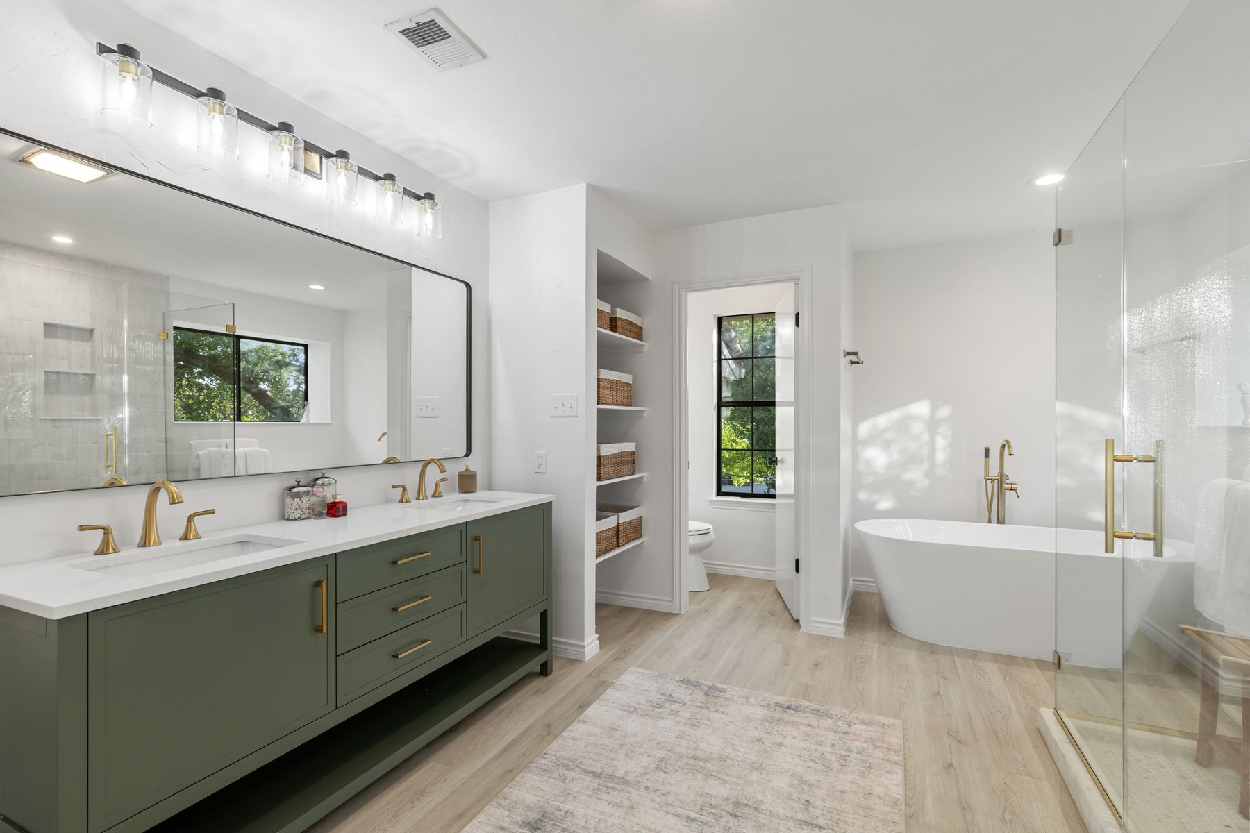 5 Valhalla Court The Hills, TX 78738 - Photo 15 of 34 Spa-like bath with dual vanities, soaking tub, and oversized glass shower.