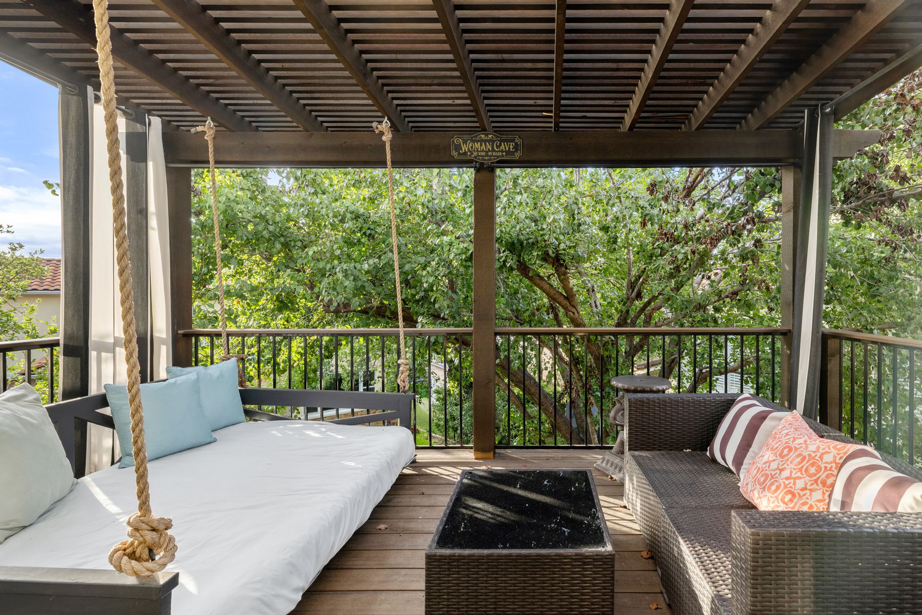 5 Valhalla Court The Hills, TX 78738 - Photo 18 of 34 Private covered deck off the primary suite—fully protected and perfect for relaxing, even during a rain shower.