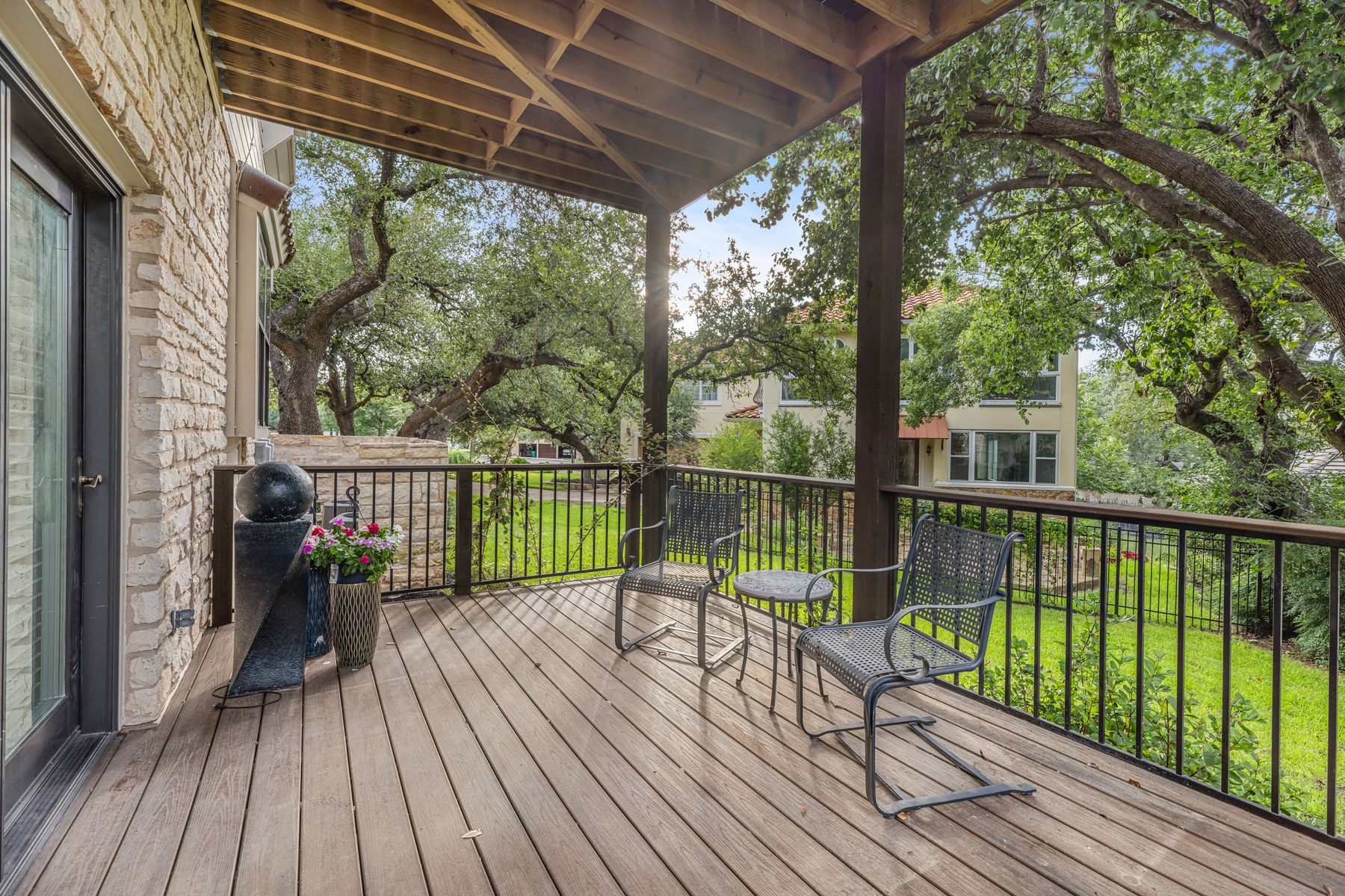 5 Valhalla Court The Hills, TX 78738 - Photo 27 of 34 One of two covered deck off the living room—fully protected and perfect for relaxing during a rain shower.