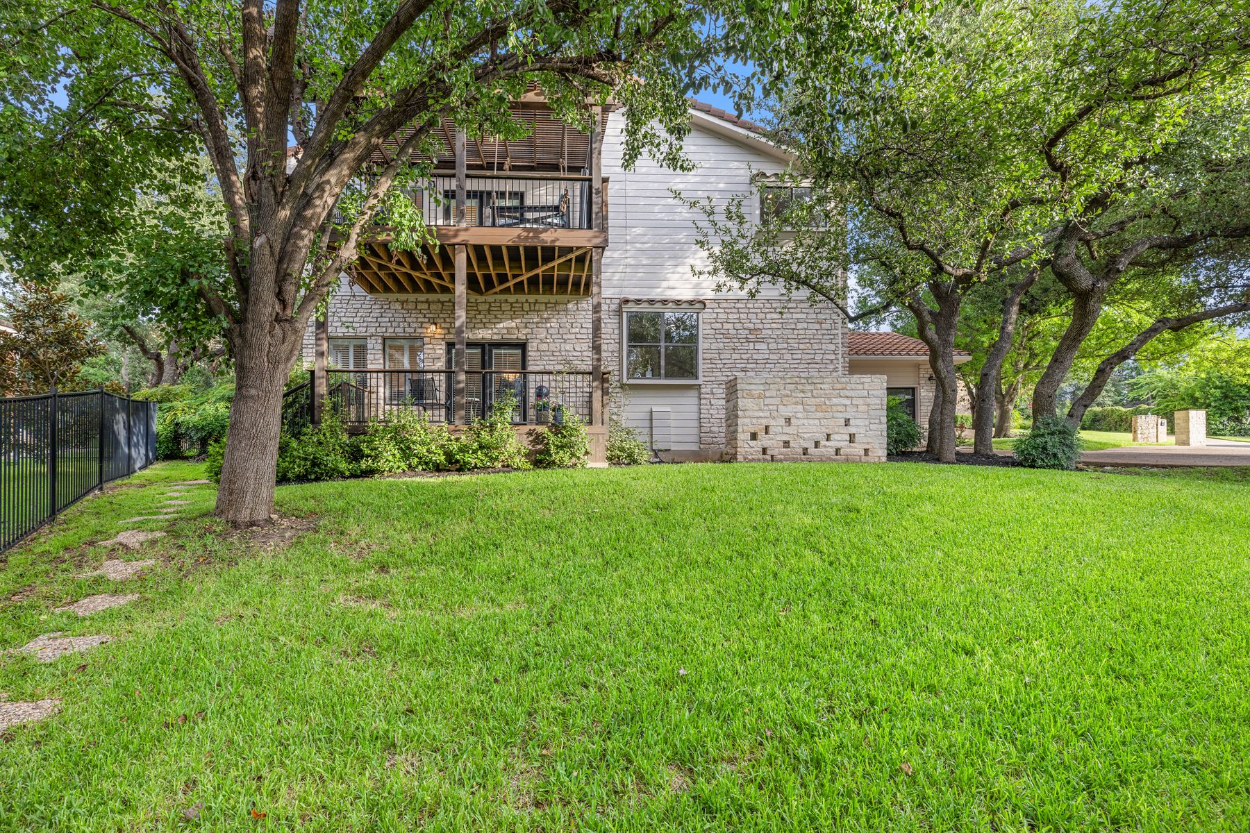 5 Valhalla Court The Hills, TX 78738 - Photo 30 of 34 Rear view of house with a balcony and stone siding