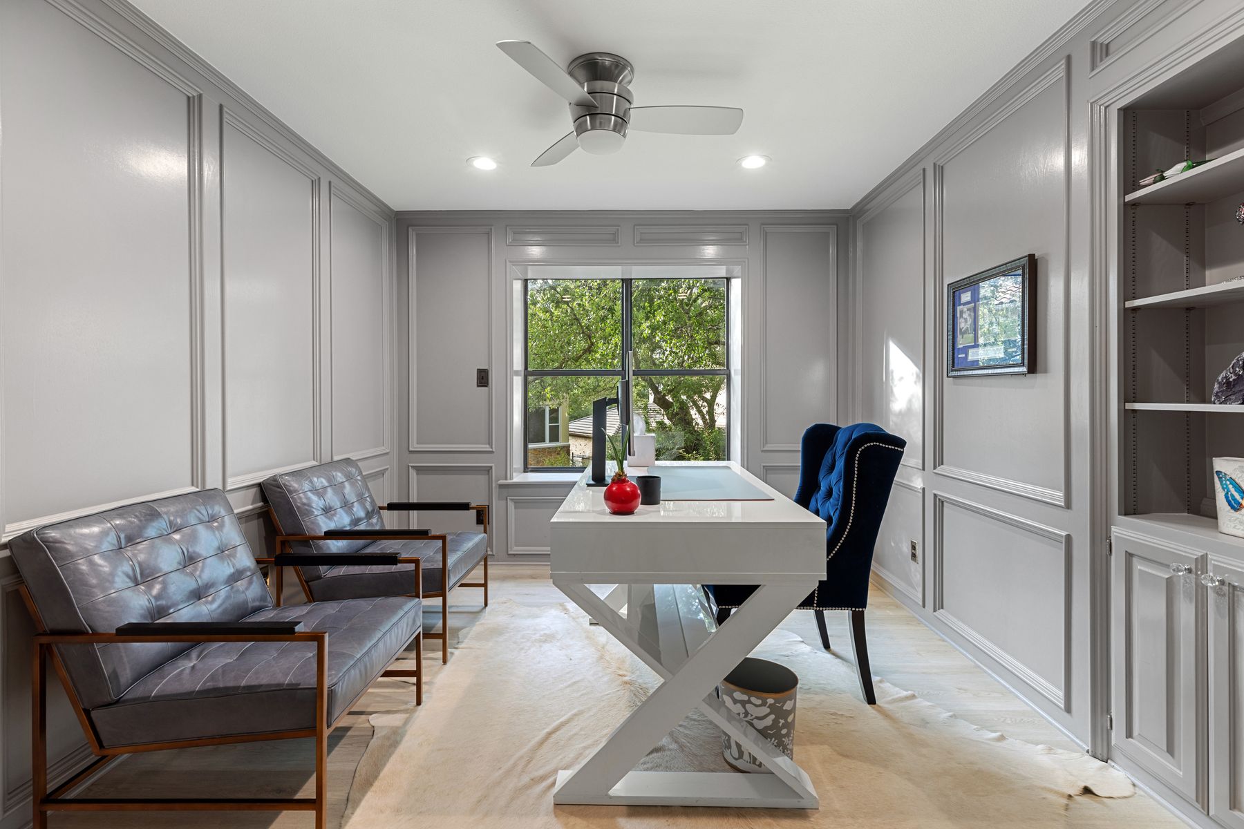 5 Valhalla Court The Hills, TX 78738 - Photo 4 of 34 The private office offers a refined and functional workspace with custom paneled walls, built-in shelving, and abundant natural light.