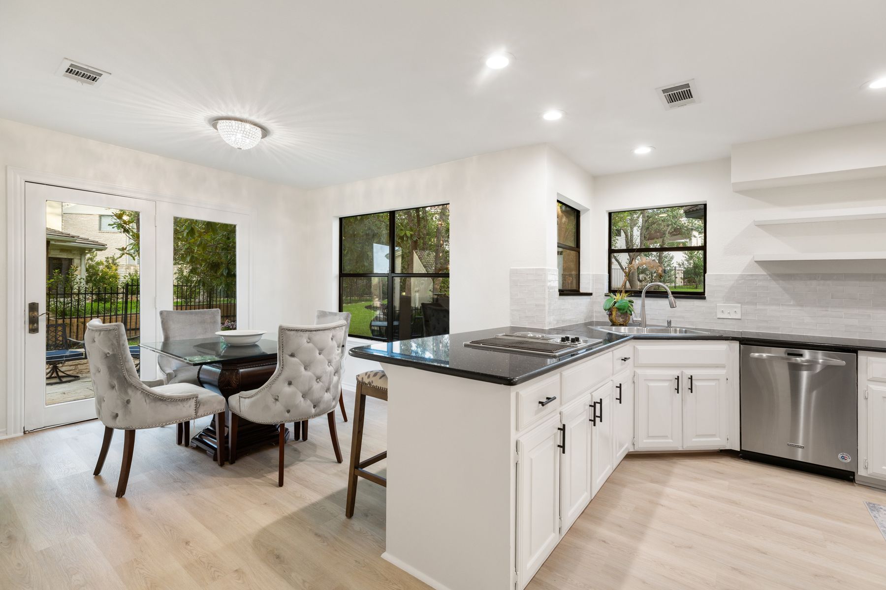 5 Valhalla Court The Hills, TX 78738 - Photo 10 of 34 The charming breakfast area is surrounded by windows and anchored by a glass door leading to the patio, allowing natural light to pour in.