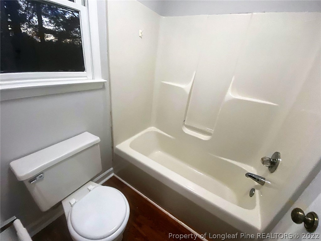 944 Flintwood Road Fayetteville, NC 28314 - Photo 12 of 50 a white toilet sitting next to a bath tub