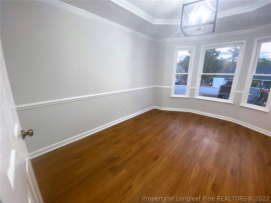 944 Flintwood Road Fayetteville, NC 28314 - Photo 13 of 50 an empty room with wooden floor and windows