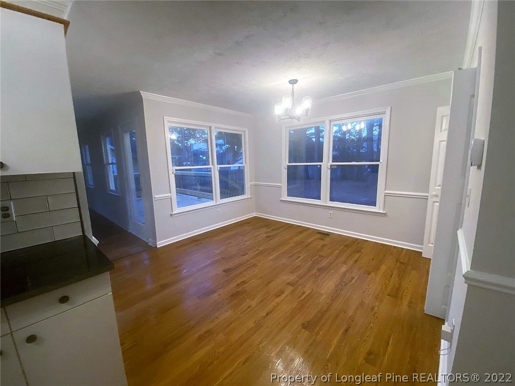 944 Flintwood Road Fayetteville, NC 28314 - Photo 15 of 50 a view of an empty room with wooden floor and a window