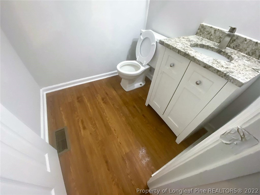 944 Flintwood Road Fayetteville, NC 28314 - Photo 17 of 50 a bathroom with a granite countertop sink and a toilet