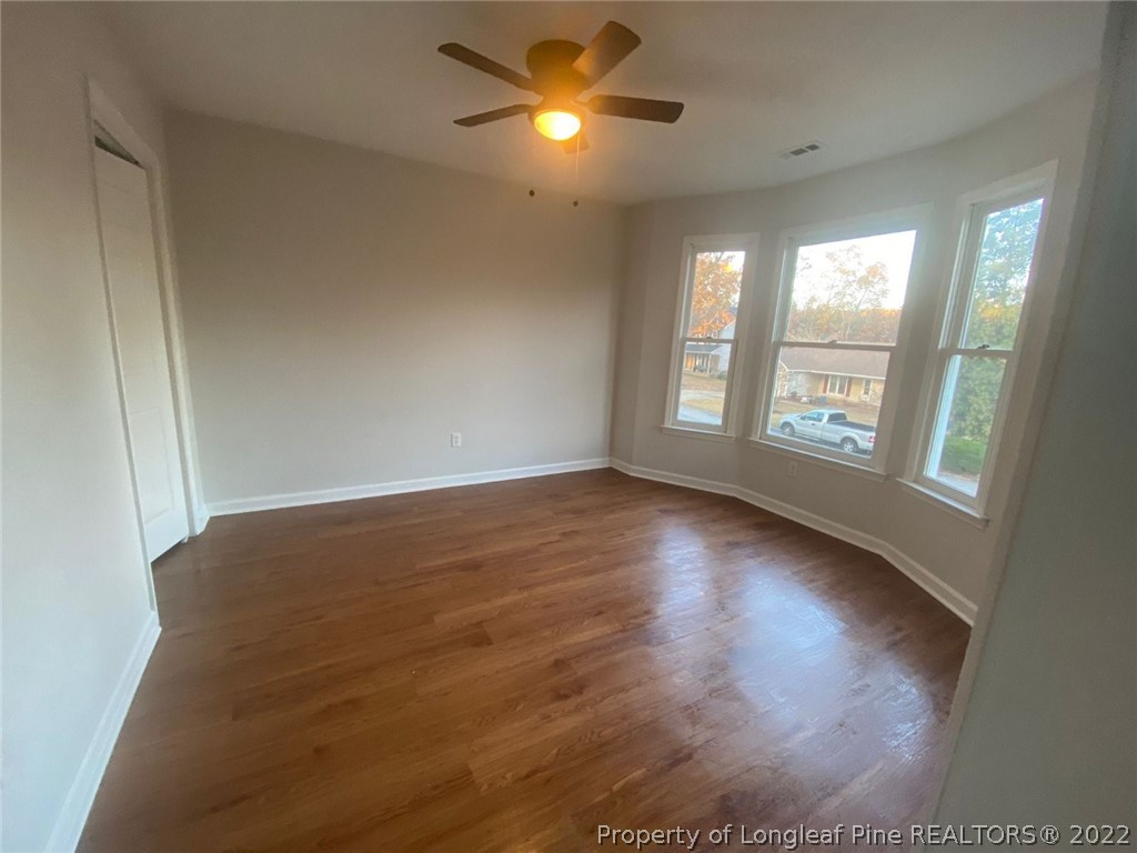 944 Flintwood Road Fayetteville, NC 28314 - Photo 19 of 50 a view of empty room with wooden floor and fan