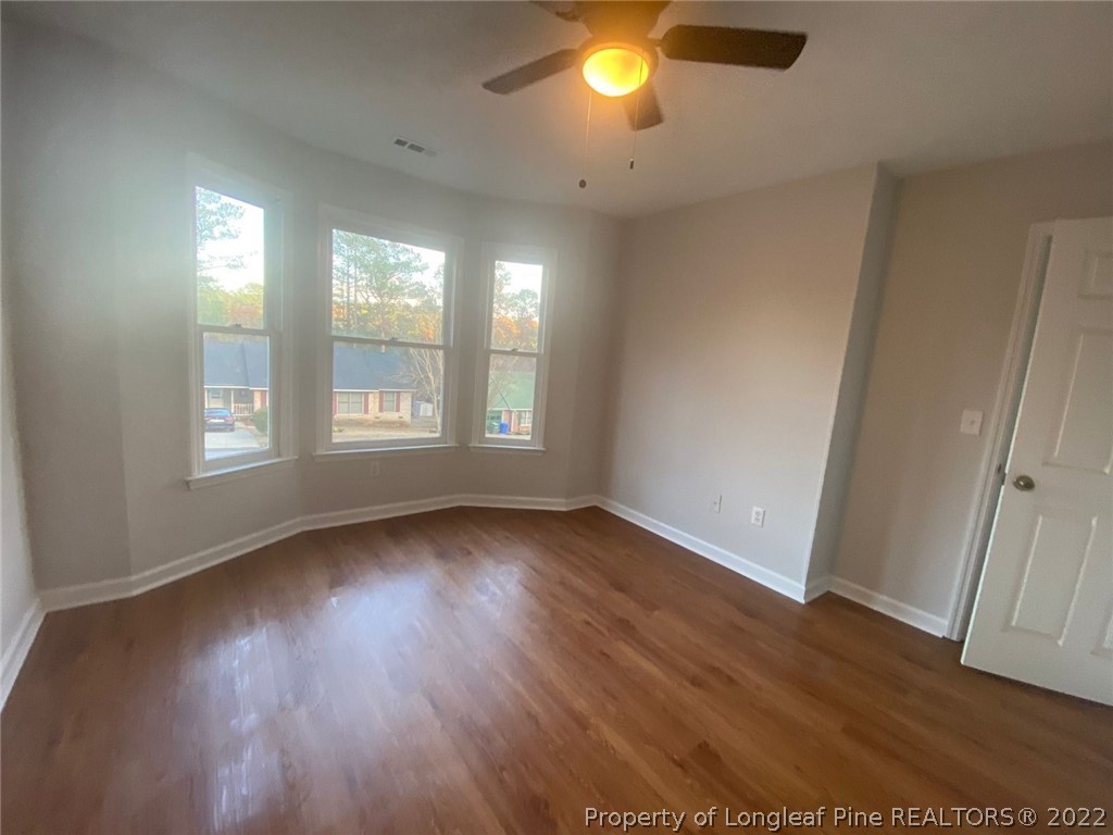 944 Flintwood Road Fayetteville, NC 28314 - Photo 20 of 50 an empty room with wooden floor and windows
