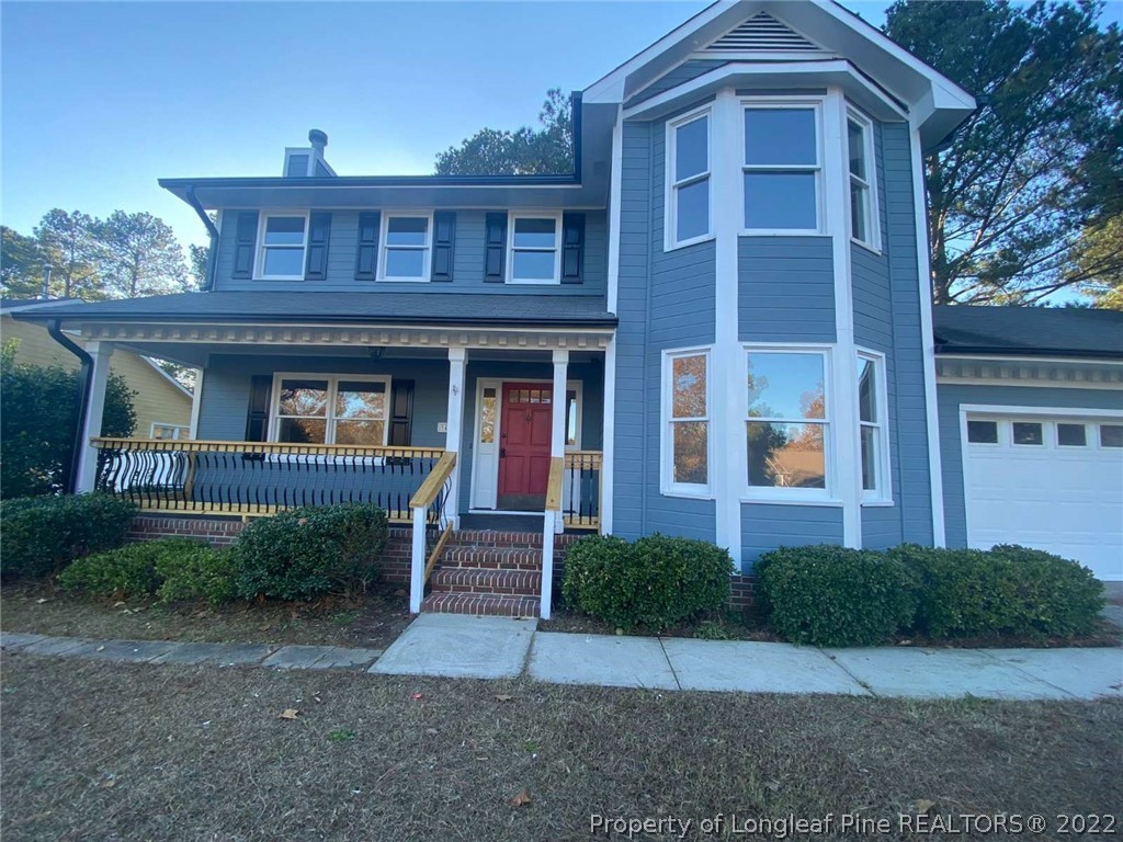 944 Flintwood Road Fayetteville, NC 28314 - Photo 2 of 50 a view of a brick house with a yard and large windows
