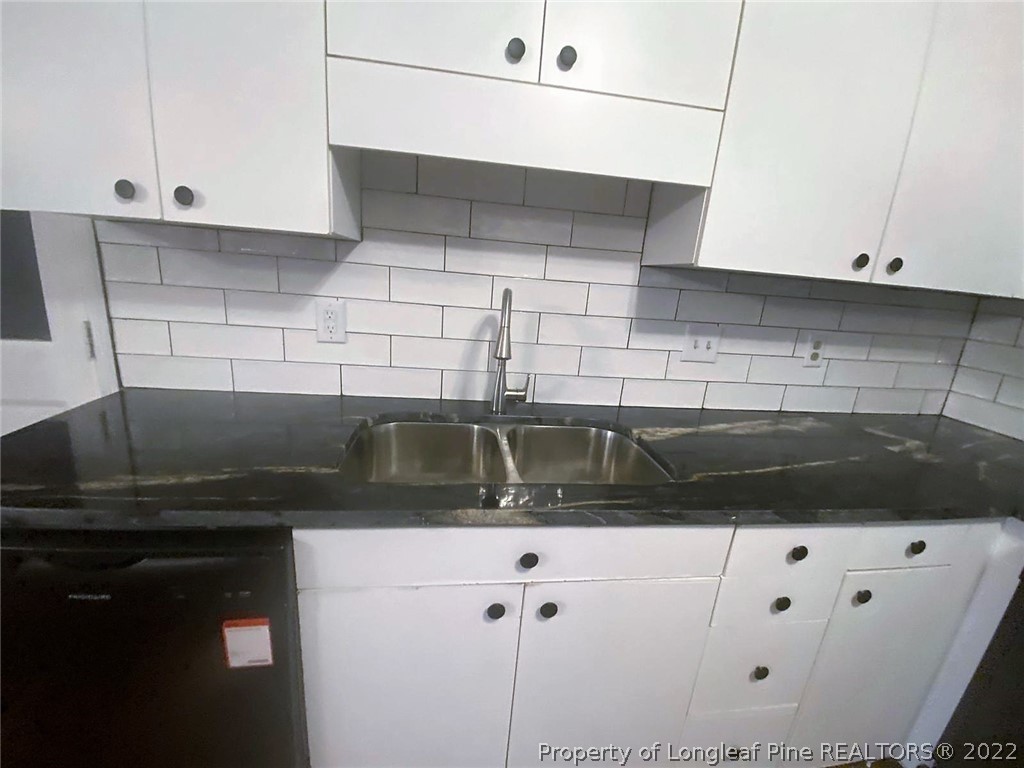 944 Flintwood Road Fayetteville, NC 28314 - Photo 25 of 50 a kitchen with a sink and cabinets