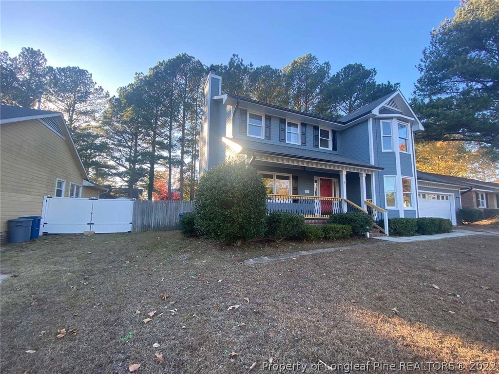 944 Flintwood Road Fayetteville, NC 28314 - Photo 3 of 50 a view of a brick house next to a yard with large trees