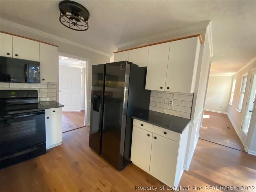 944 Flintwood Road Fayetteville, NC 28314 - Photo 39 of 50 a kitchen with a refrigerator and a stove top oven