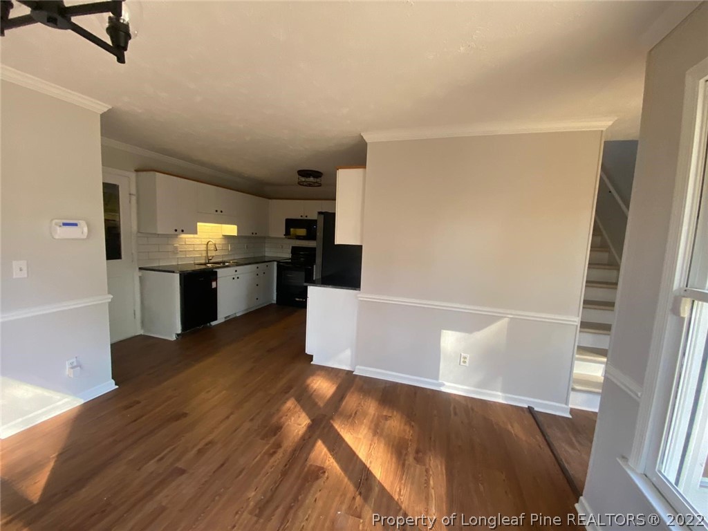 944 Flintwood Road Fayetteville, NC 28314 - Photo 42 of 50 a view of a kitchen with furniture and an empty room
