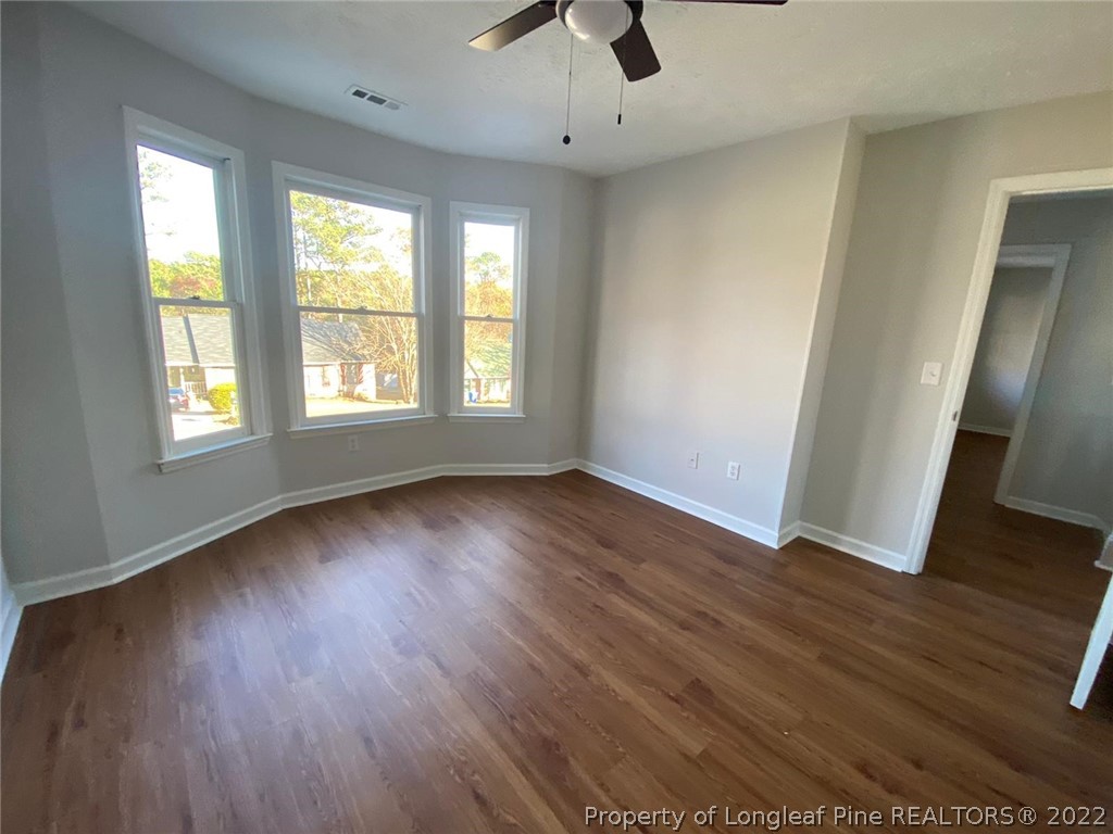 944 Flintwood Road Fayetteville, NC 28314 - Photo 44 of 50 an empty room with wooden floor and windows