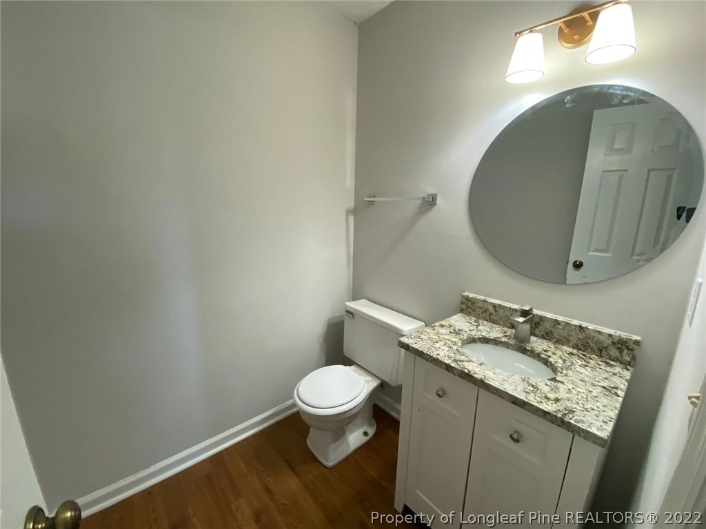 944 Flintwood Road Fayetteville, NC 28314 - Photo 49 of 50 a bathroom with a granite countertop toilet and a sink