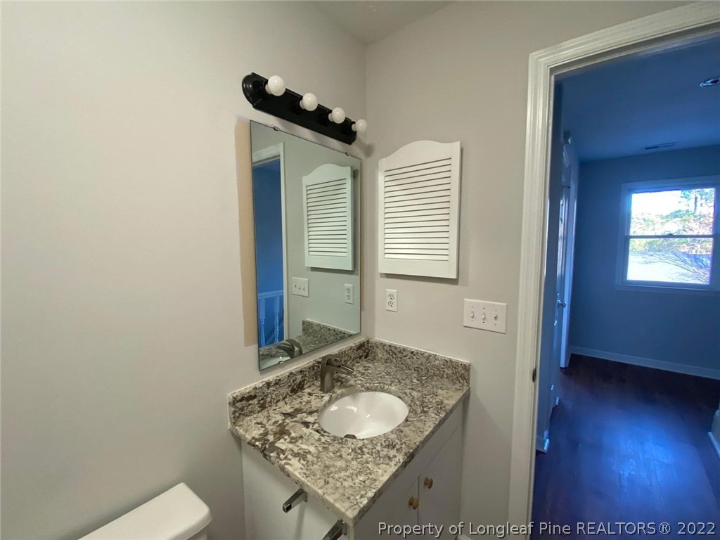 944 Flintwood Road Fayetteville, NC 28314 - Photo 50 of 50 a bathroom with a granite countertop sink and a mirror