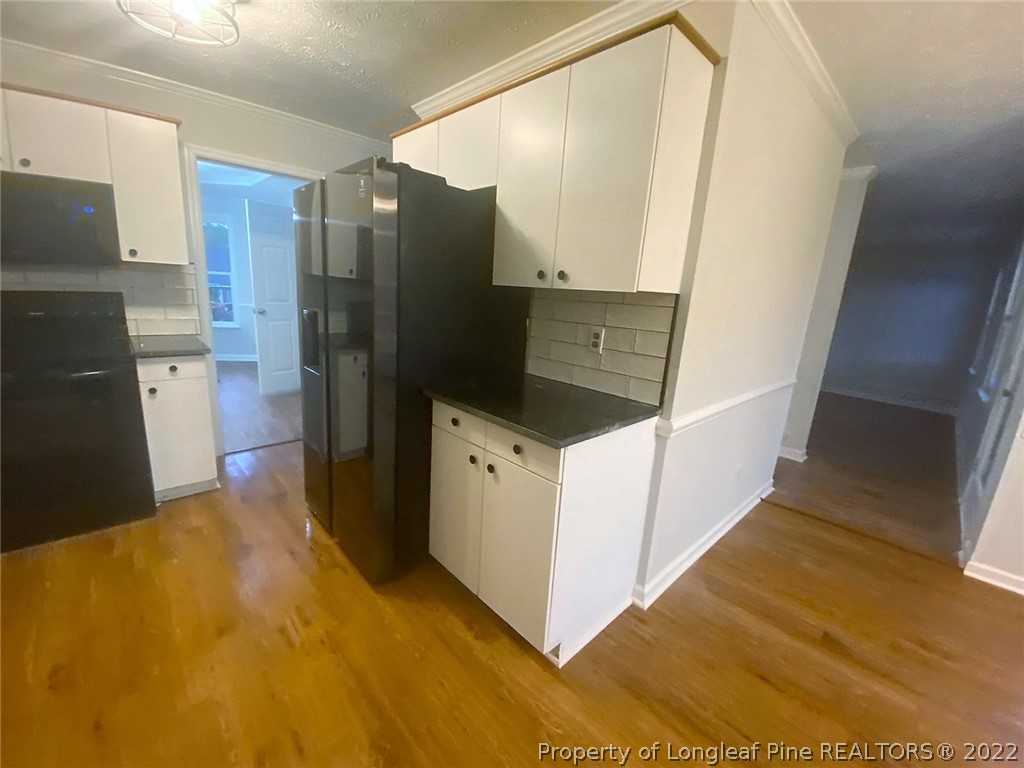 944 Flintwood Road Fayetteville, NC 28314 - Photo 7 of 50 a kitchen with stainless steel appliances a refrigerator and a stove