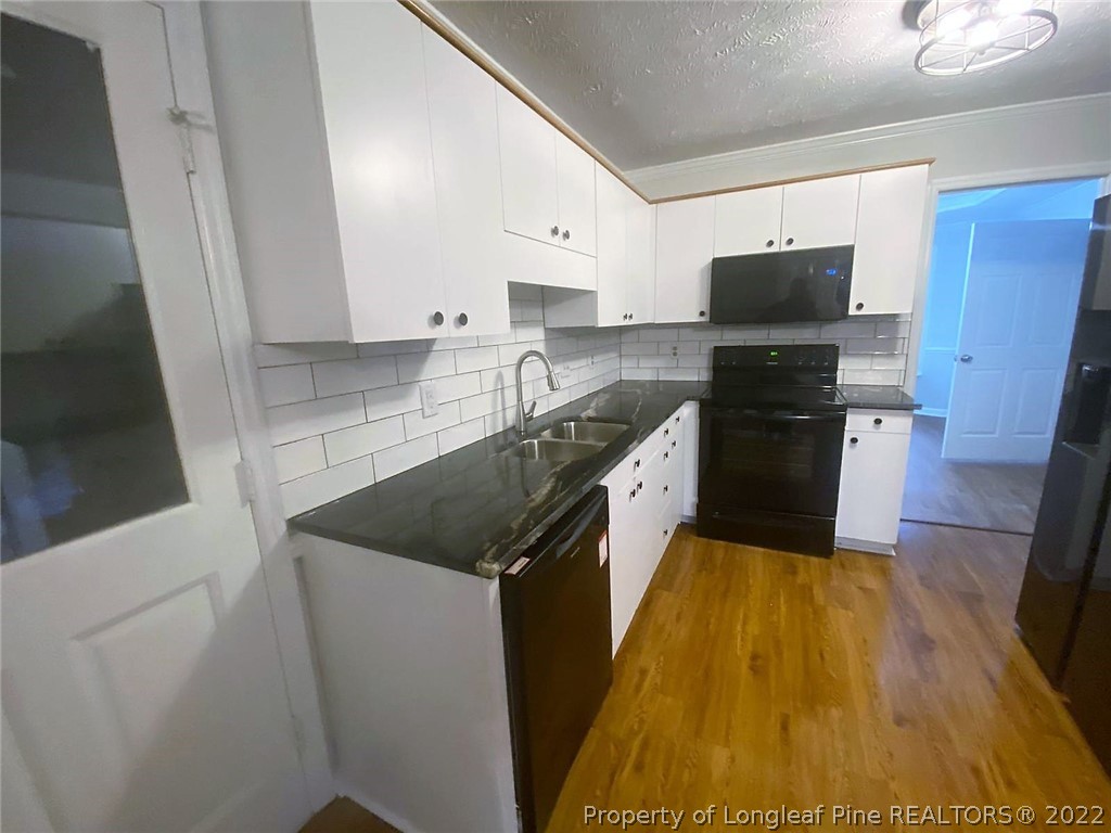 944 Flintwood Road Fayetteville, NC 28314 - Photo 8 of 50 a kitchen with stainless steel appliances granite countertop a sink and a stove top oven