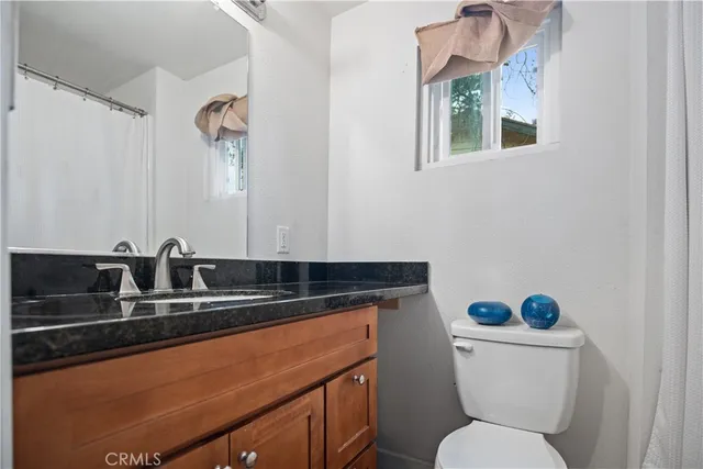 a bathroom with a sink a toilet and a mirror