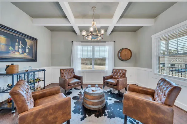 a living room with furniture a chandelier and a large window