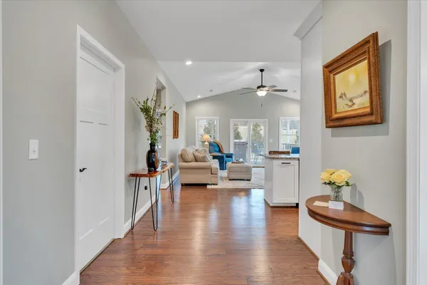 a living room with furniture appliances and wooden floor