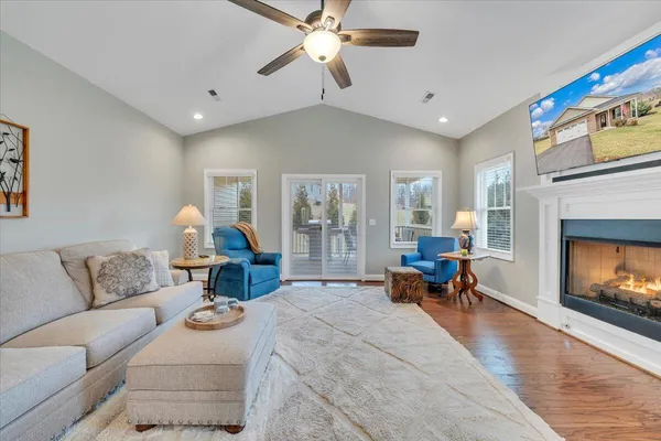 a living room with furniture and a fireplace