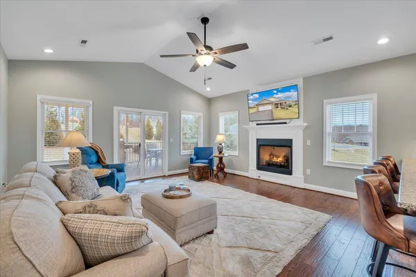 a living room with furniture and a fireplace