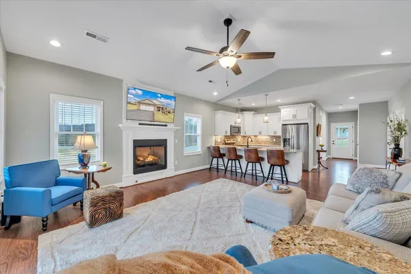 a living room with furniture and wooden floor