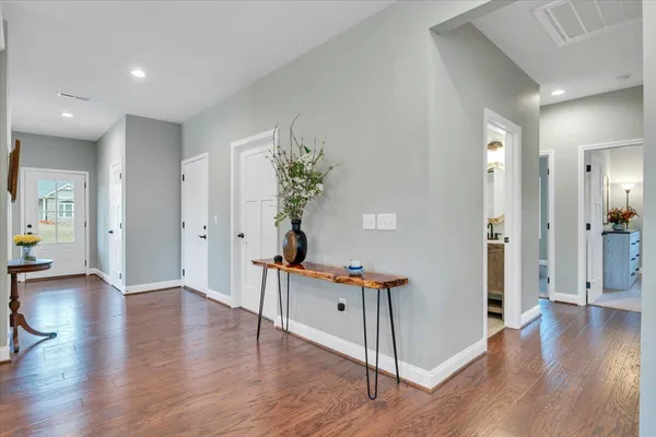 a view of a hallway with wooden floor