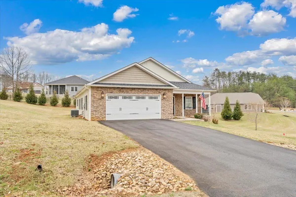 a view of a house with a swimming pool and a yard