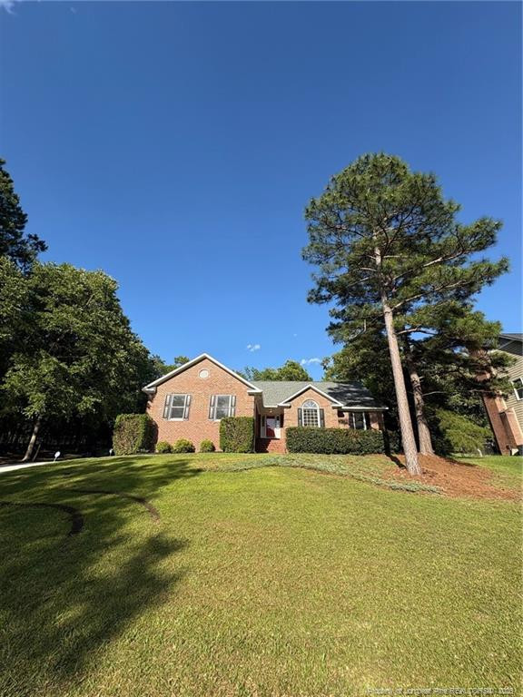 6976 Kings Lynn Loop Fayetteville, NC 28304 - Photo 1 of 10 a view of a house with a yard