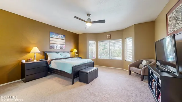 a spacious bedroom with a bed and window