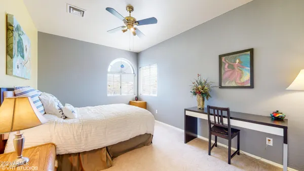 a bedroom with a bed and a chandelier