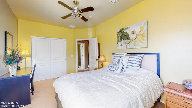 a bedroom with a bed and a painting on the wall