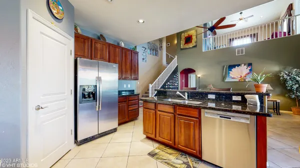 a kitchen with stainless steel appliances granite countertop a refrigerator and a stove