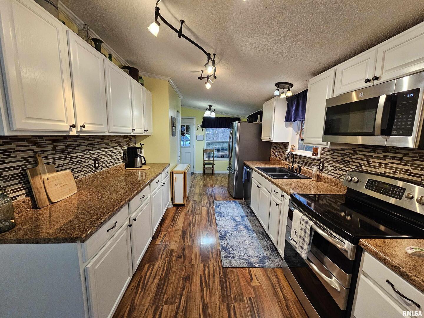 18266 East Liberty Road Opdyke, IL 62872 - Photo 20 of 34 a kitchen with stainless steel appliances granite countertop a stove a sink and a microwave