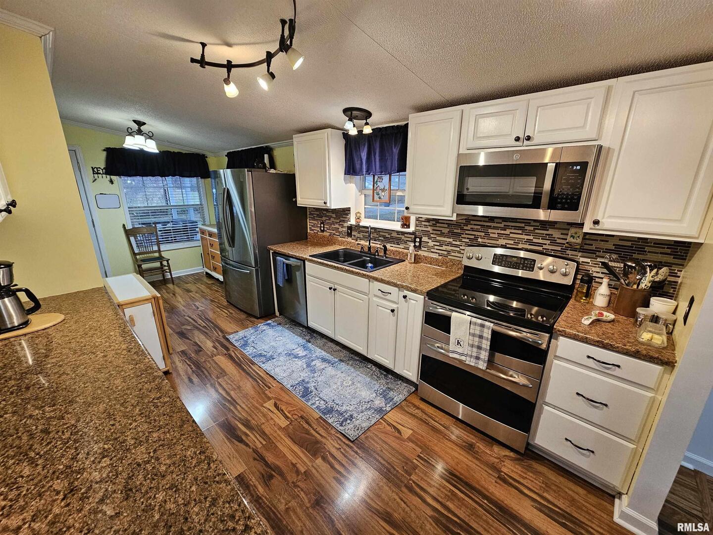 18266 East Liberty Road Opdyke, IL 62872 - Photo 22 of 34 a kitchen with stainless steel appliances granite countertop a stove and a sink