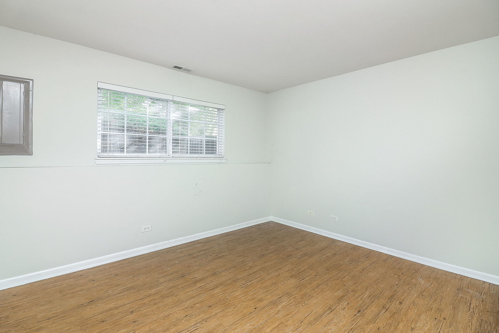 317 Timber Ridge Court, Unit 131 Joliet, IL 60431 - Photo 16 of 23 wooden floor in an empty room with a window
