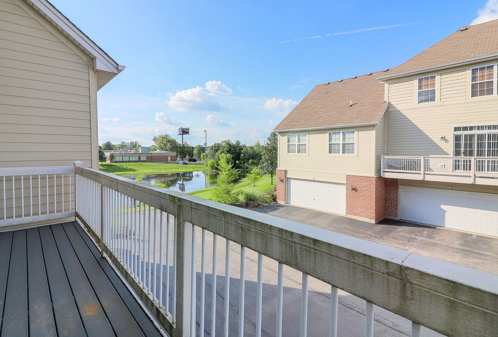 317 Timber Ridge Court, Unit 131 Joliet, IL 60431 - Photo 18 of 23 a view of a balcony with wooden floor and fence