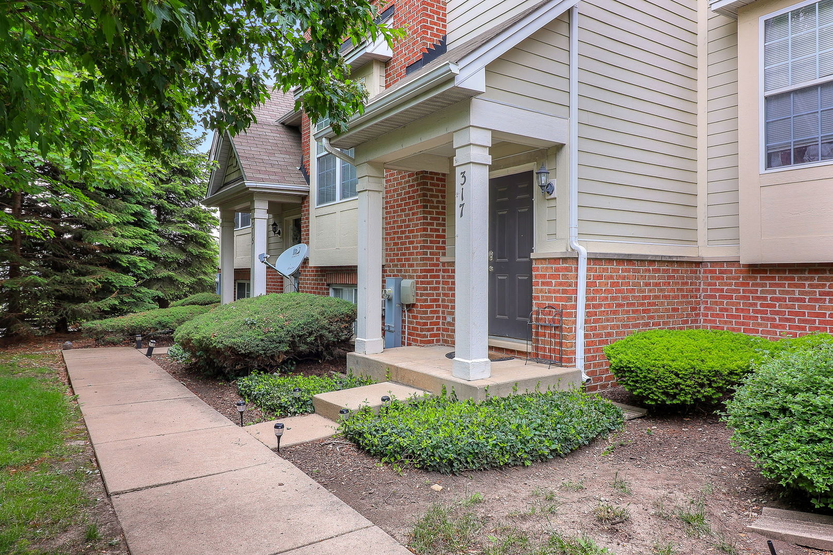 317 Timber Ridge Court, Unit 131 Joliet, IL 60431 - Photo 2 of 23 a front view of a house with a yard